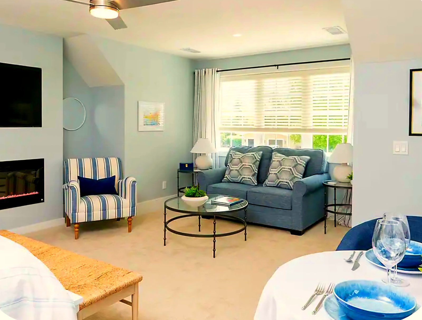 King Suite living area with fireplace, TV, armchair, and dining table